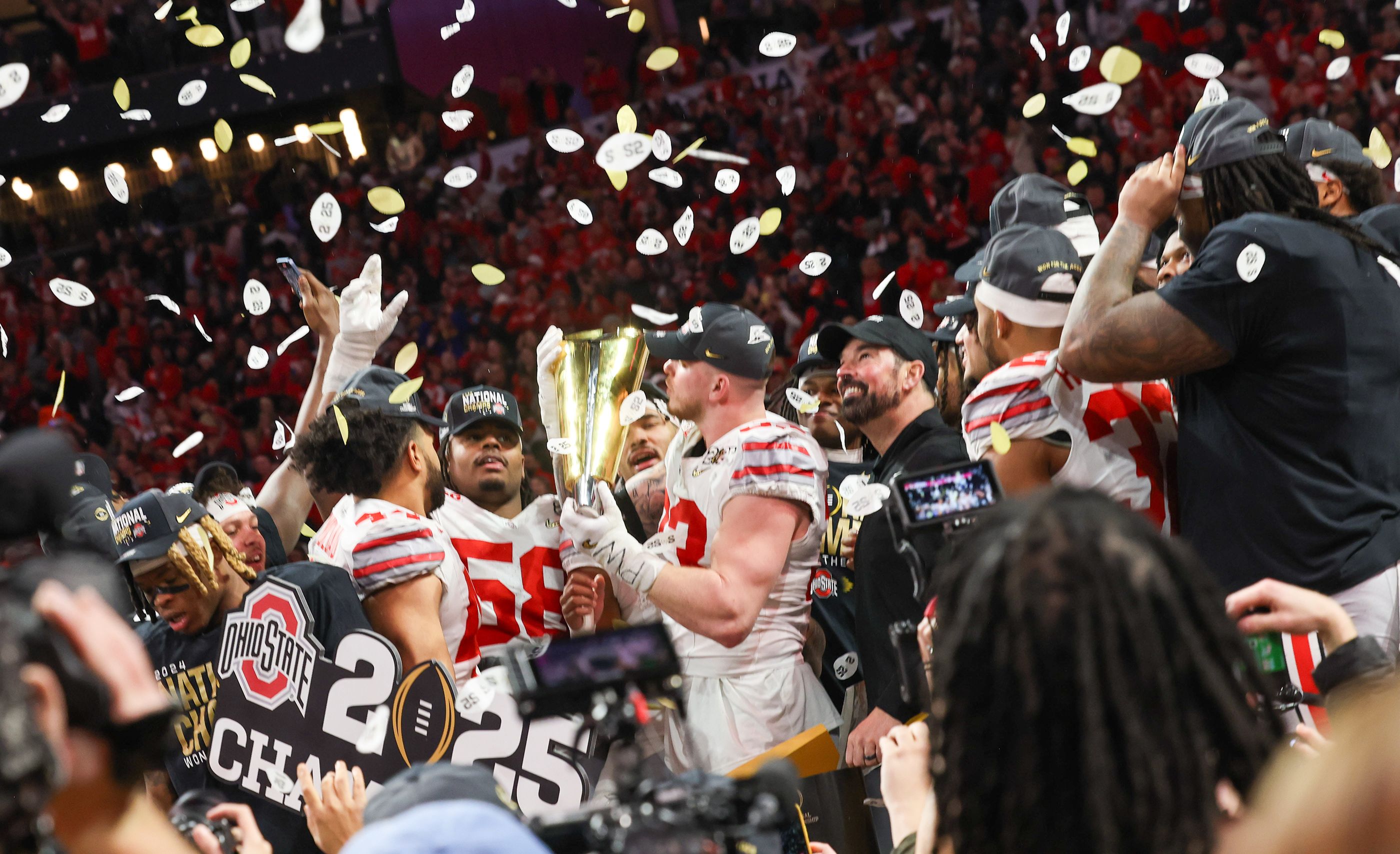 Ohio State's Jack Sawyer kisses the national championship trophy after the Buckeyes claimed their ninth national title.